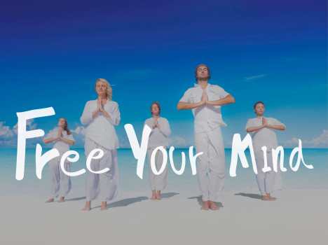 People standing on beach practicing Yoga